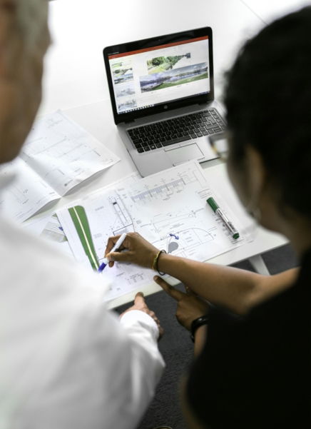 woman in white shirt writing on white paper